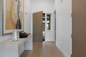Hall featuring light wood-style flooring and an office area
