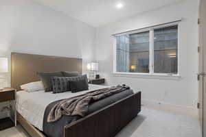 Bedroom featuring baseboards and light colored carpet