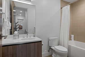 Bathroom with vanity and shower / tub combo