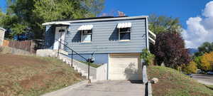 View of front facade with driveway and a garage