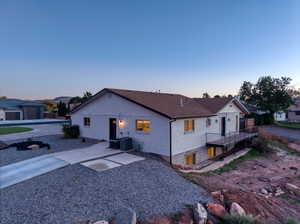 Back of house featuring a patio, brick siding, and a wooden deck