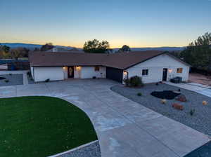 Single story home with concrete driveway, an attached garage, and brick siding