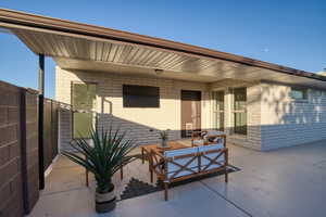 View of patio with an outdoor hangout area