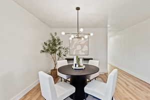 Dining area featuring a chandelier and light wood-style floors