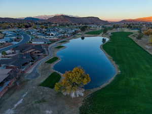 Aerial overview of property's location with a water and mountain view and nearby suburban area