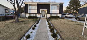 Split foyer home with mansard roof and roof with shingles