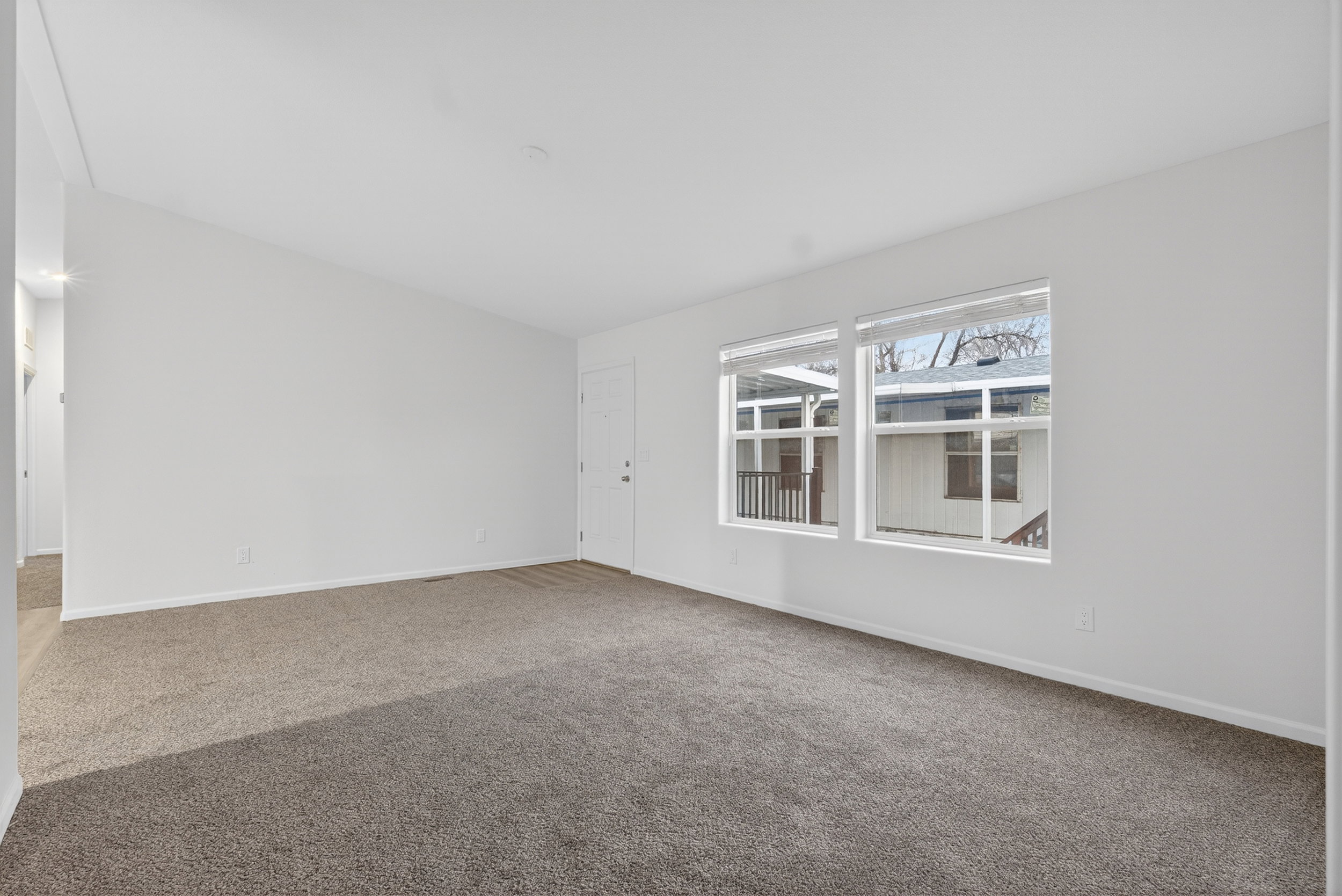 Unfurnished room featuring carpet flooring and baseboards