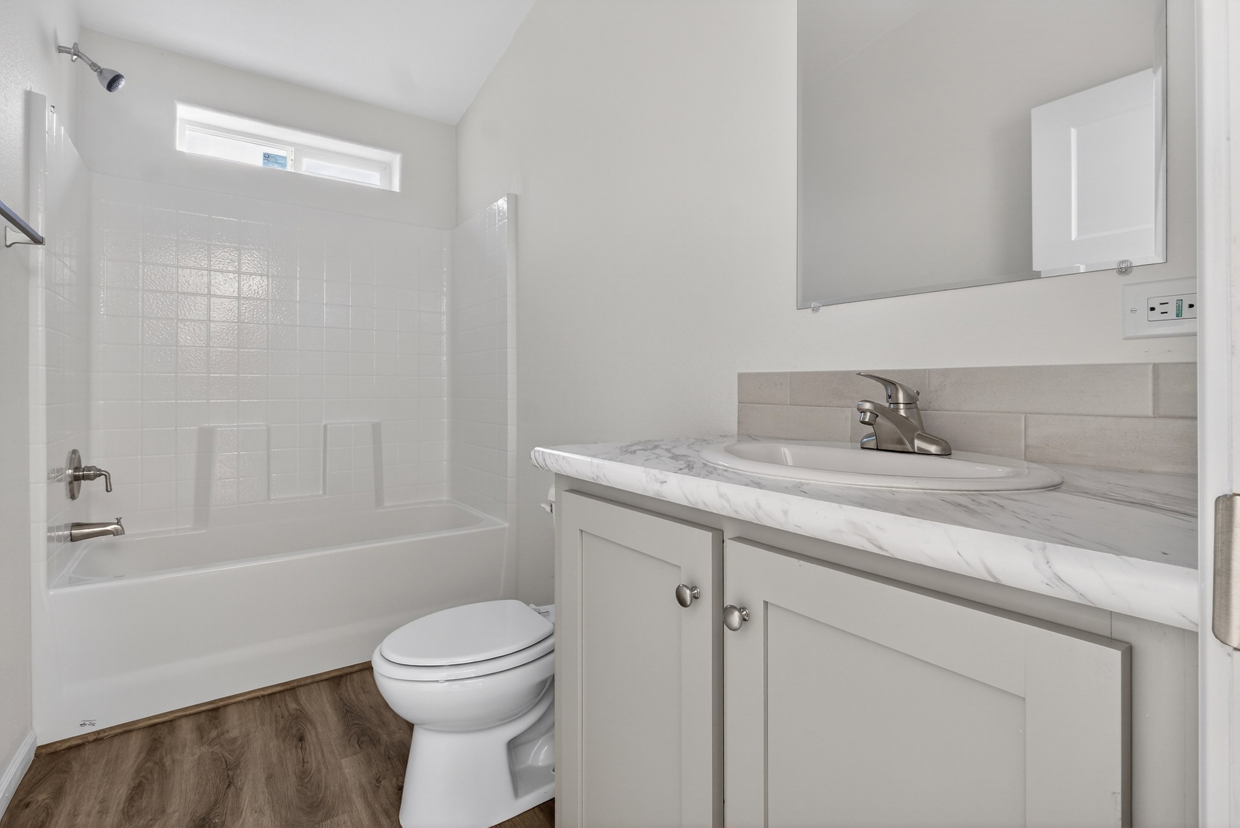 Full bath featuring vanity, tub / shower combination, and dark wood-style floors
