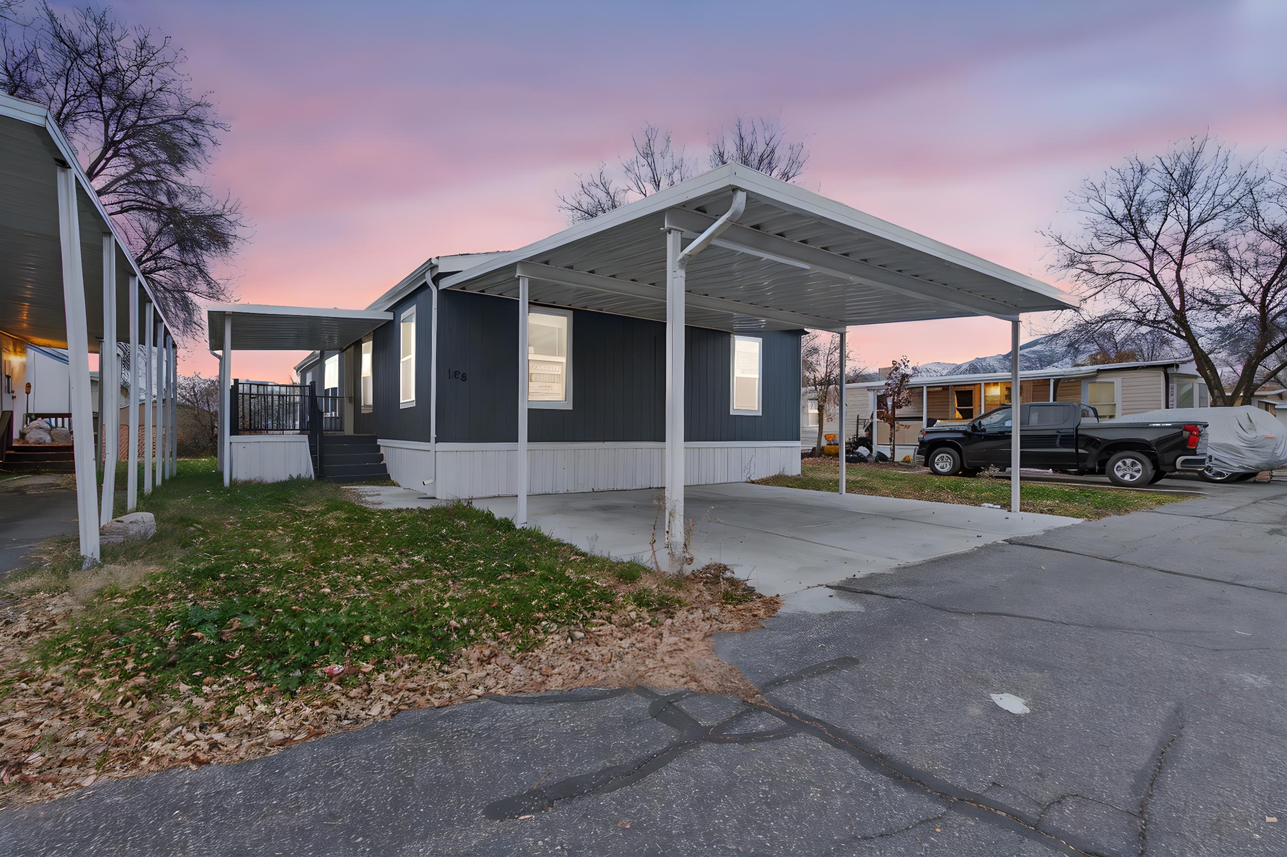 View of property exterior with an attached carport and concrete driveway