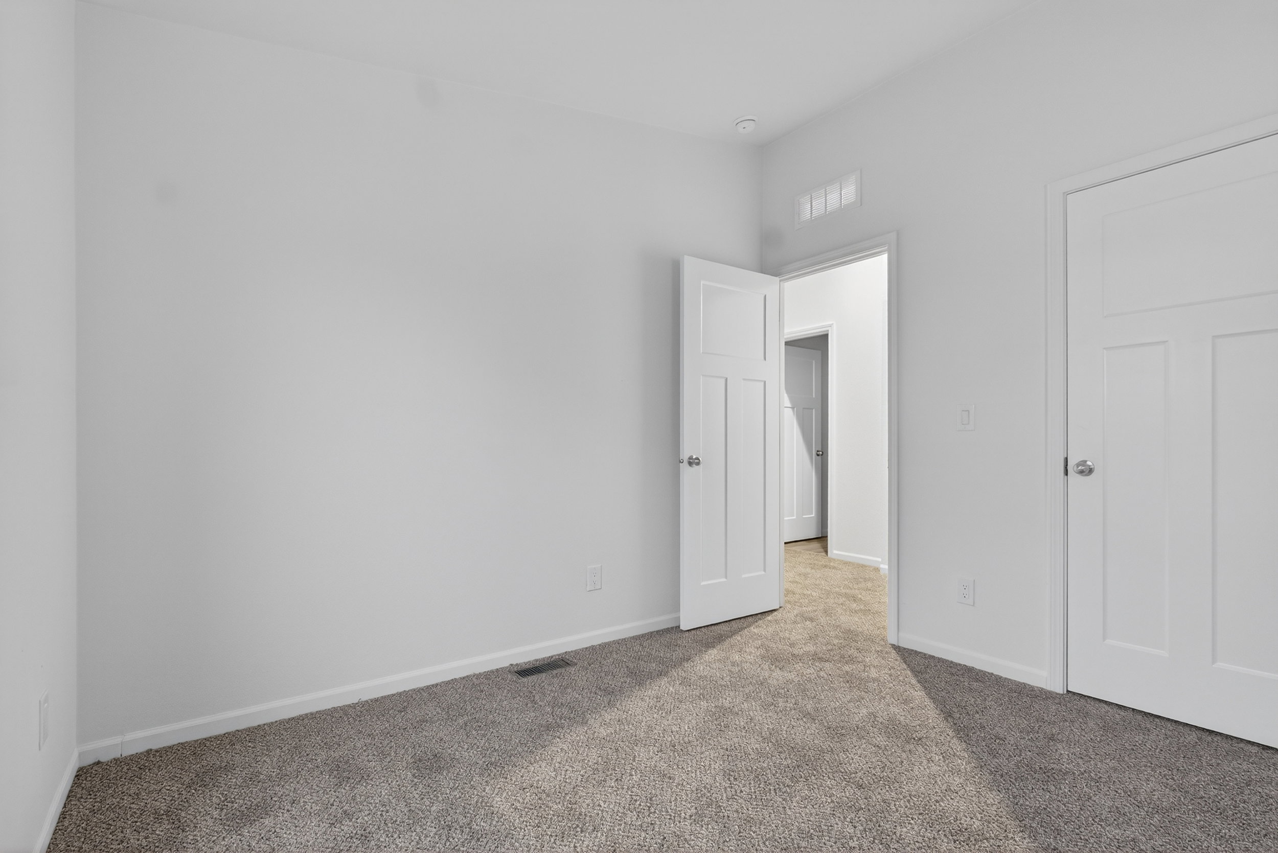 Unfurnished bedroom with carpet floors and baseboards