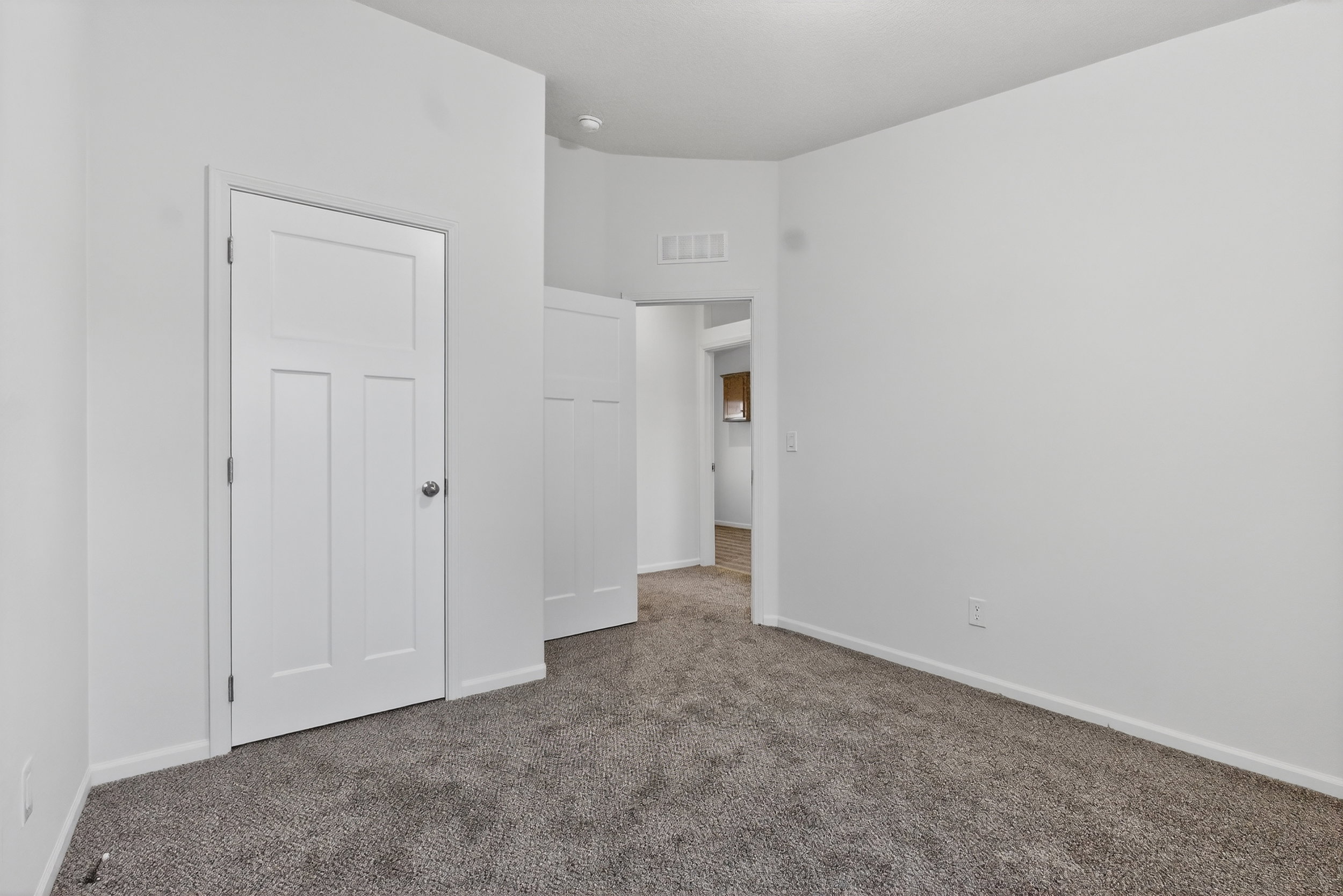 Unfurnished bedroom featuring carpet floors and baseboards