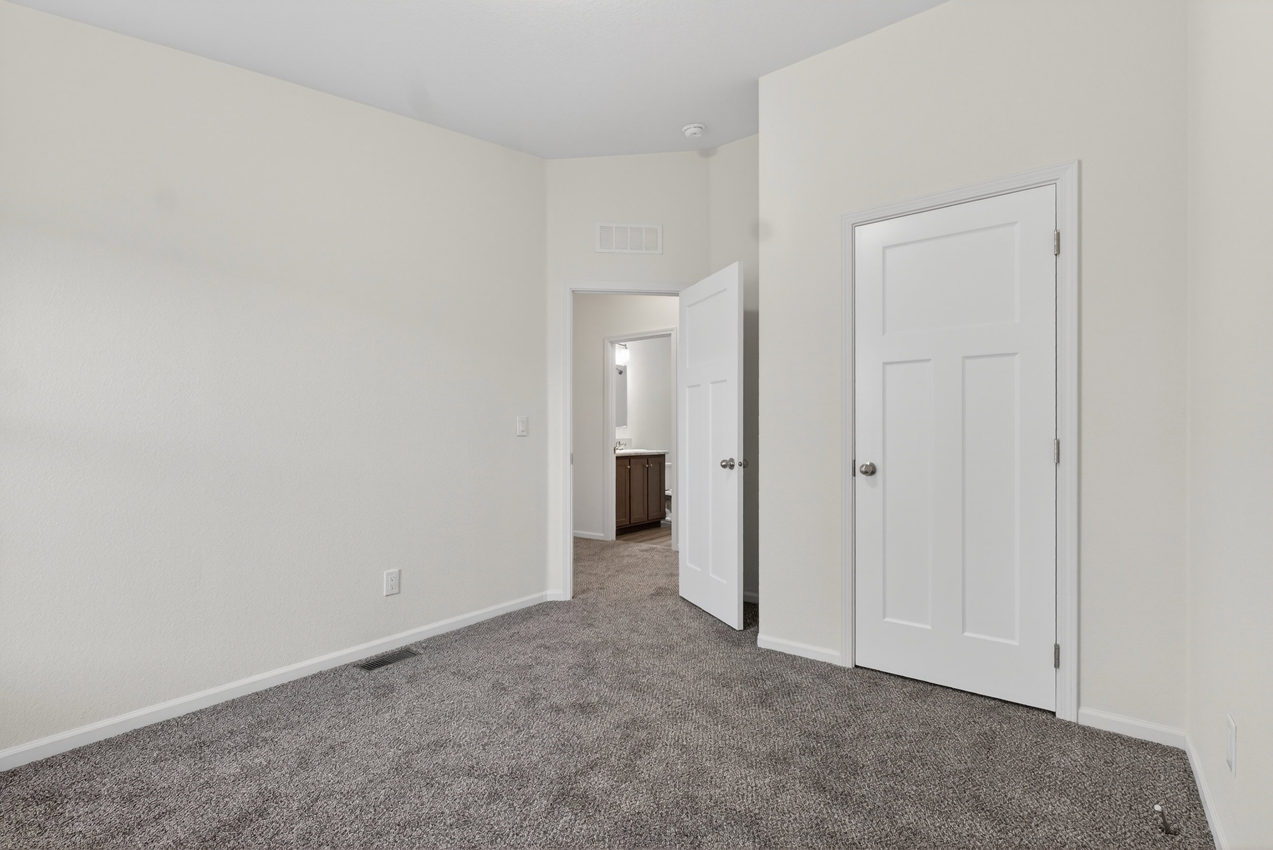 Unfurnished bedroom featuring carpet floors and baseboards
