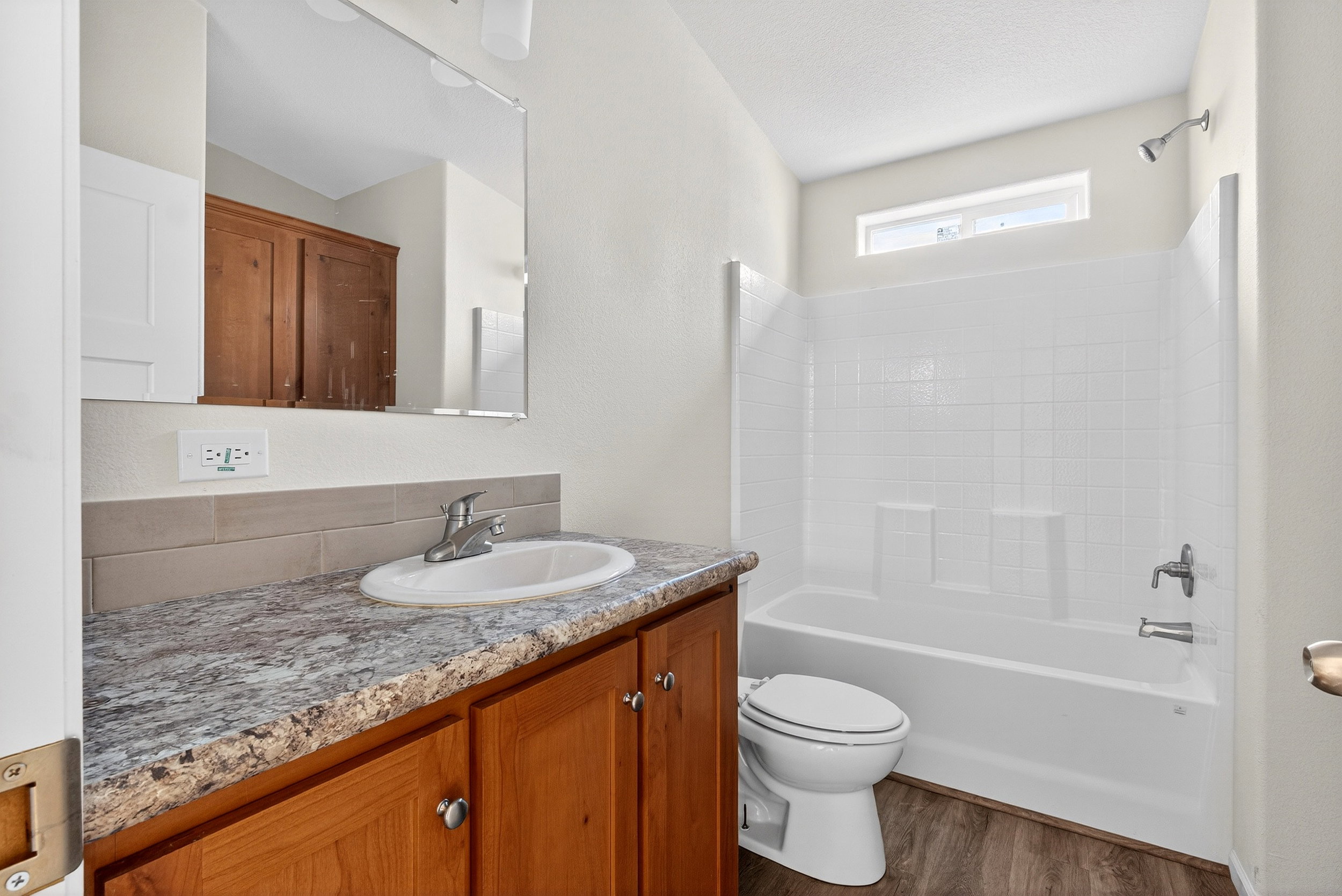Full bath featuring vanity, shower / bath combination, and dark wood finished floors
