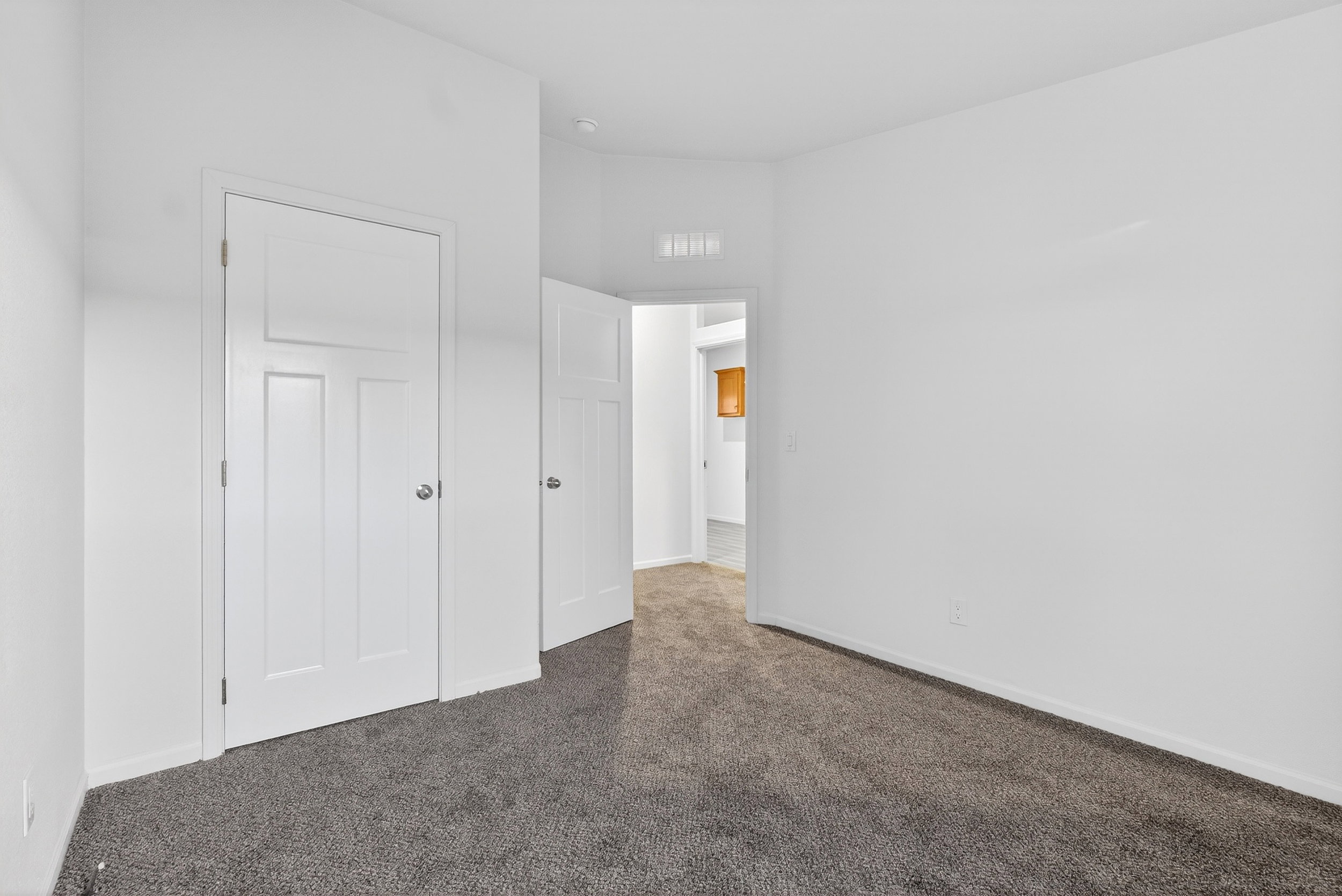 Unfurnished bedroom featuring carpet flooring and baseboards