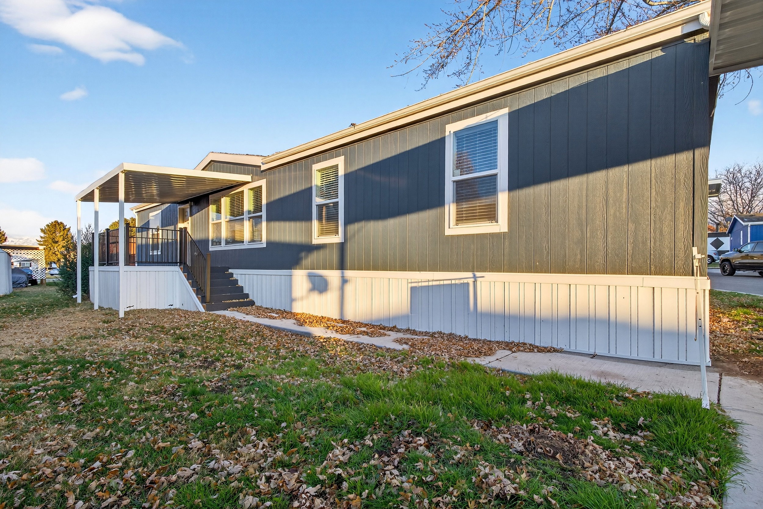 View of side of home with a wooden deck