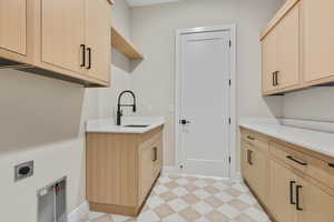 Washroom featuring light floors, cabinet space, and hookup for an electric dryer