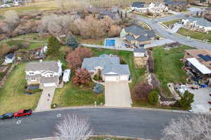 Aerial view of property and surrounding area featuring nearby suburban area