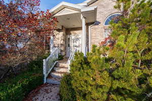 Doorway to property with brick siding