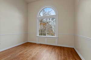 Empty room with light wood-style flooring and baseboards