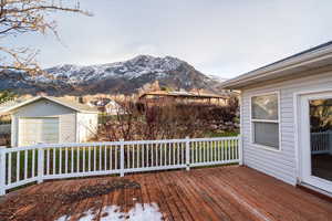 Wooden terrace with a mountain view, a garage, and an outdoor structure