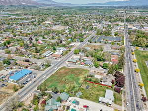 Aerial view of property and surrounding area with property boundaries highlighted and a mountainous background