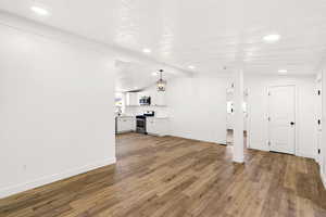 Unfurnished living room with dark wood-style flooring, recessed lighting, and a textured ceiling