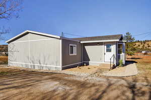 Rear view of house with roof with shingles