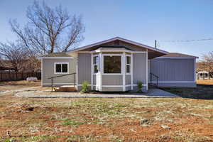 View of front of home featuring roof with shingles