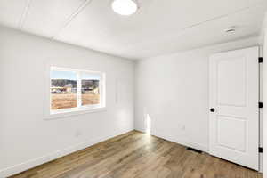 Spare room with light wood-type flooring and baseboards