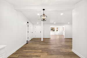 Hall featuring light wood-style flooring, a chandelier, and recessed lighting