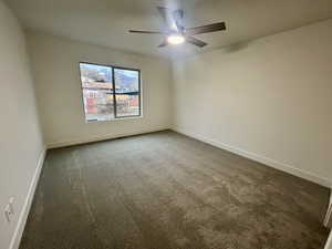 Unfurnished room with carpet flooring and ceiling fan