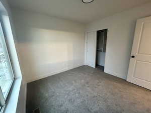 Unfurnished bedroom with carpet floors and a closet