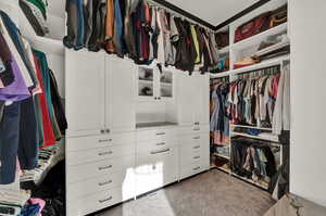 Spacious closet with light carpet