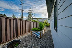 Fenced backyard featuring a vegetable garden