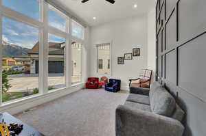 Living area with carpet, a ceiling fan, a mountain view, and recessed lighting