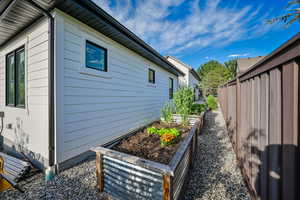 View of property exterior with a garden