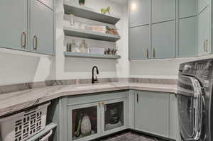 Laundry area featuring washer / clothes dryer and cabinet space