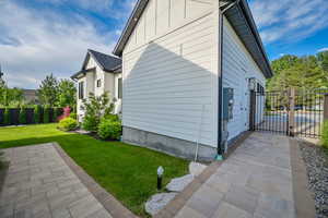 View of home's exterior with a gate and board and batten siding