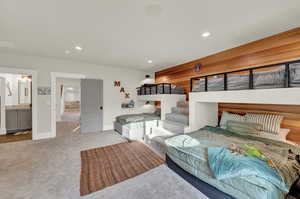 Bedroom featuring carpet floors, recessed lighting, and ensuite bath