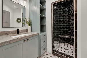Bathroom featuring vanity and a shower stall