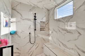 Full bathroom featuring a marble finish shower