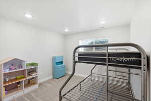 Bedroom featuring light colored carpet and recessed lighting