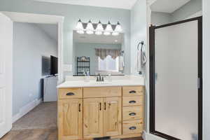 Bathroom with vanity, a stall shower, and dark colored carpet