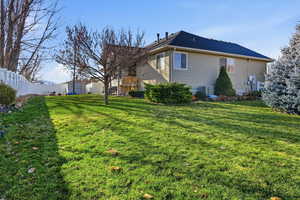 View of home's exterior with a storage unit and a fenced backyard