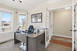 Office area with a wainscoted wall and french doors