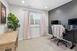 Office area with light colored carpet and recessed lighting