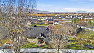 Aerial view of property's location with nearby suburban area and mountains