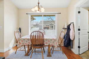 Dining room with a chandelier and wood finished floors
