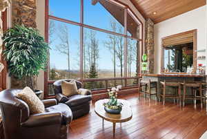 Sunroom / solarium featuring vaulted ceiling and a mountain view