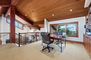 Home office with recessed lighting, light colored carpet, plenty of natural light, and wooden ceiling